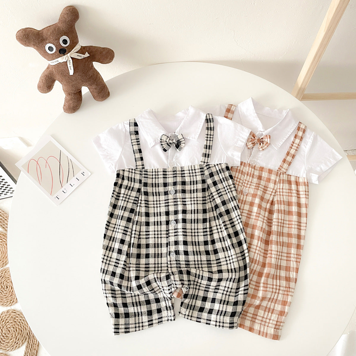 Baby boy plaid pattern polo-neck romper in black and coffee colors, made from soft cotton fabric.