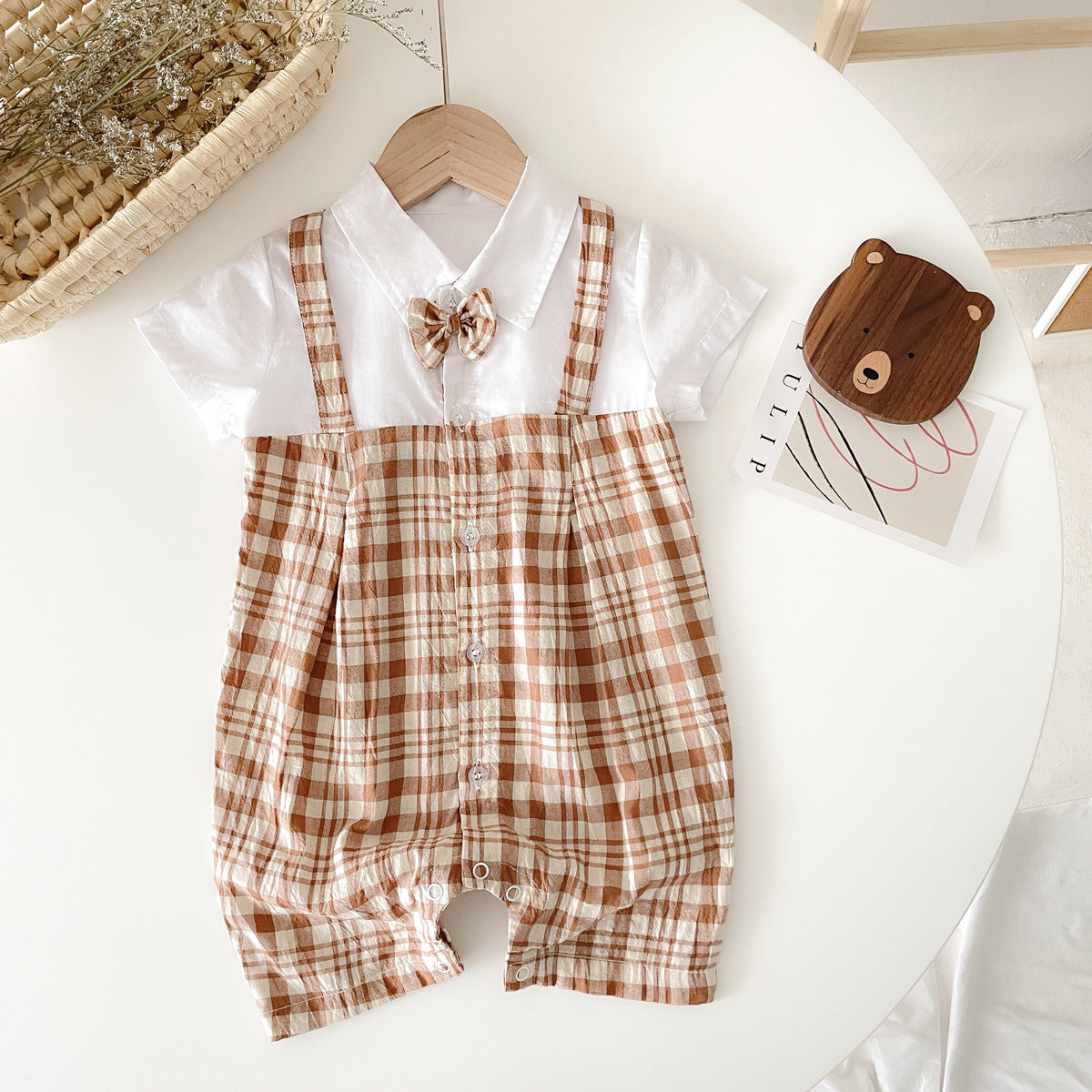 Baby boy plaid pattern polo-neck romper in black and coffee colors, made from soft cotton fabric.