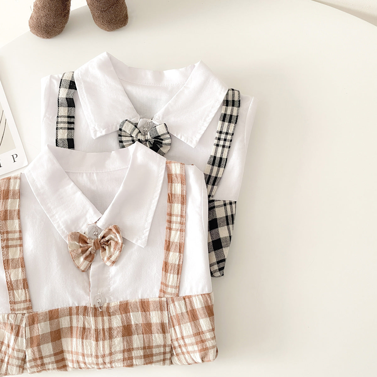 Baby boy plaid pattern polo-neck romper in black and coffee colors, made from soft cotton fabric.