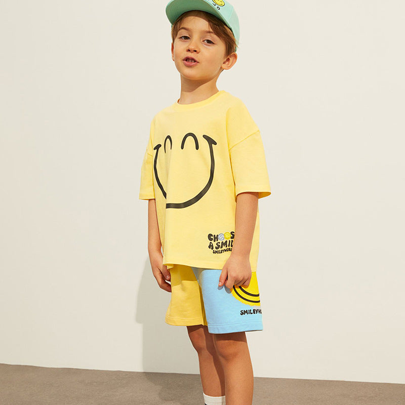 Baby boy clothing set featuring a bright yellow smile print pattern, made from soft cotton, perfect for summer wear.