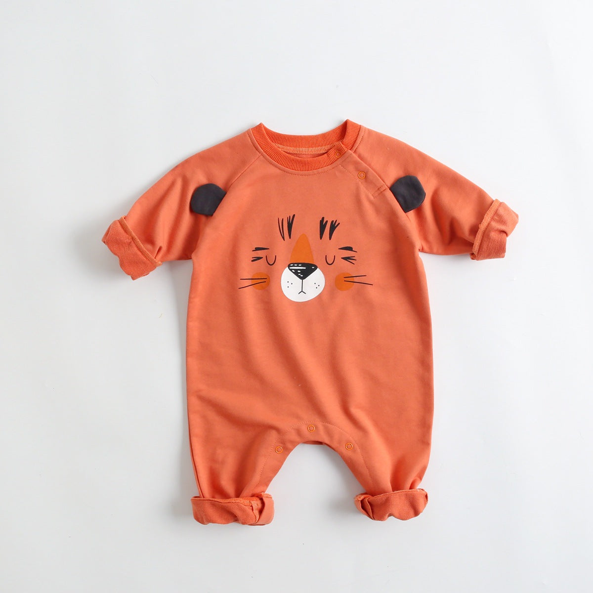 A soft cotton baby romper featuring a cute cartoon animal pattern, designed for comfort with long sleeves and footed legs.