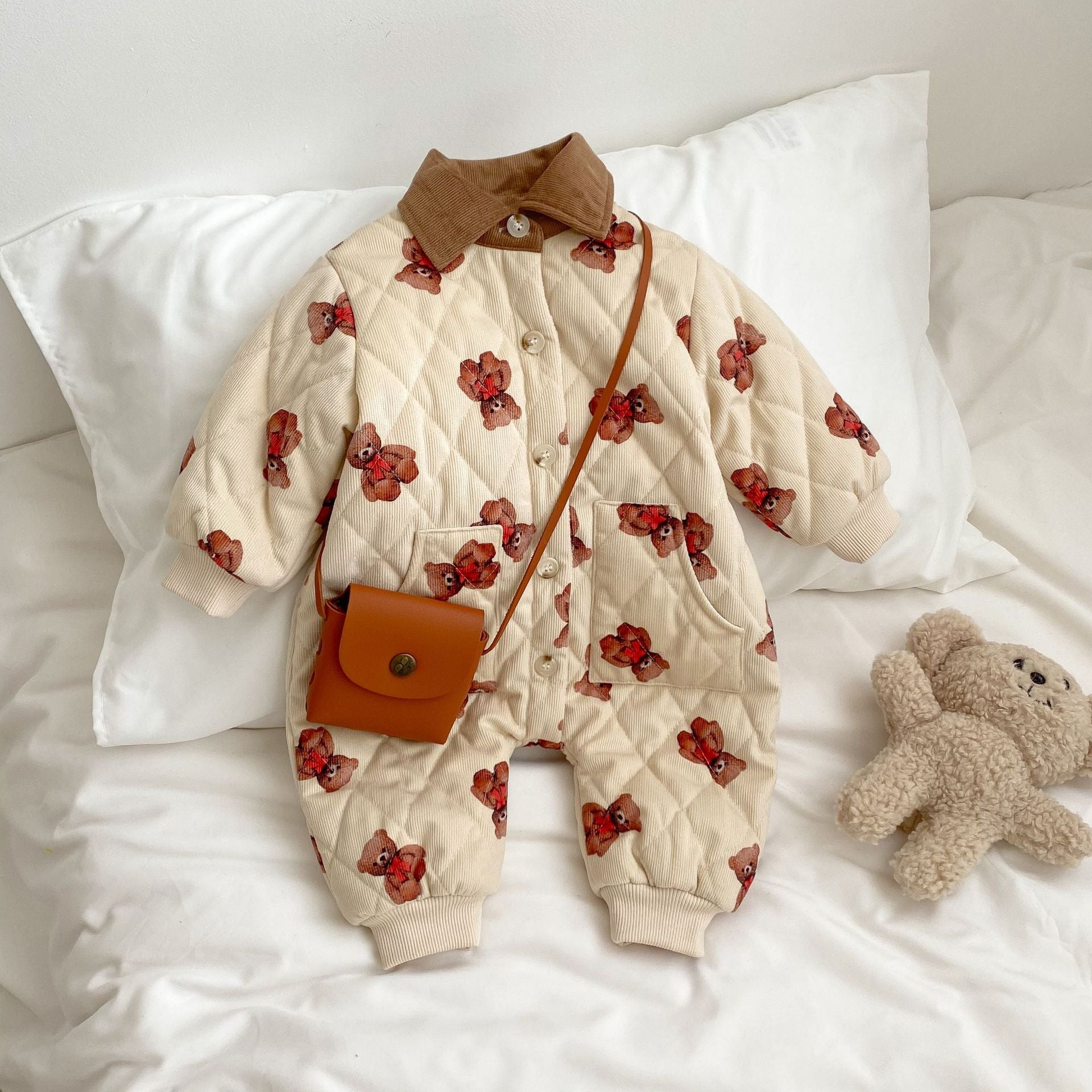 A cozy quilted baby dress featuring a cute cartoon bear graphic, available in brown and coffee colors.