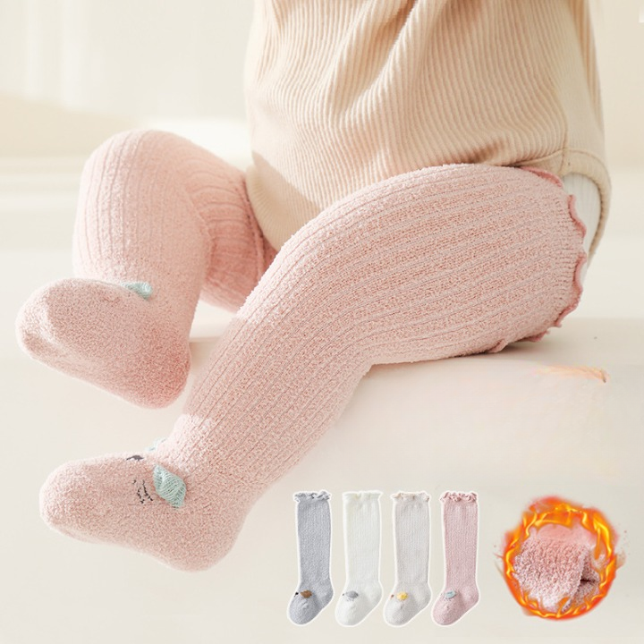 A pair of cozy Baby Cartoon Design Coral Fleece Wooden Ear Thickened Long Tube Socks in various colors, featuring a cute cartoon pattern.