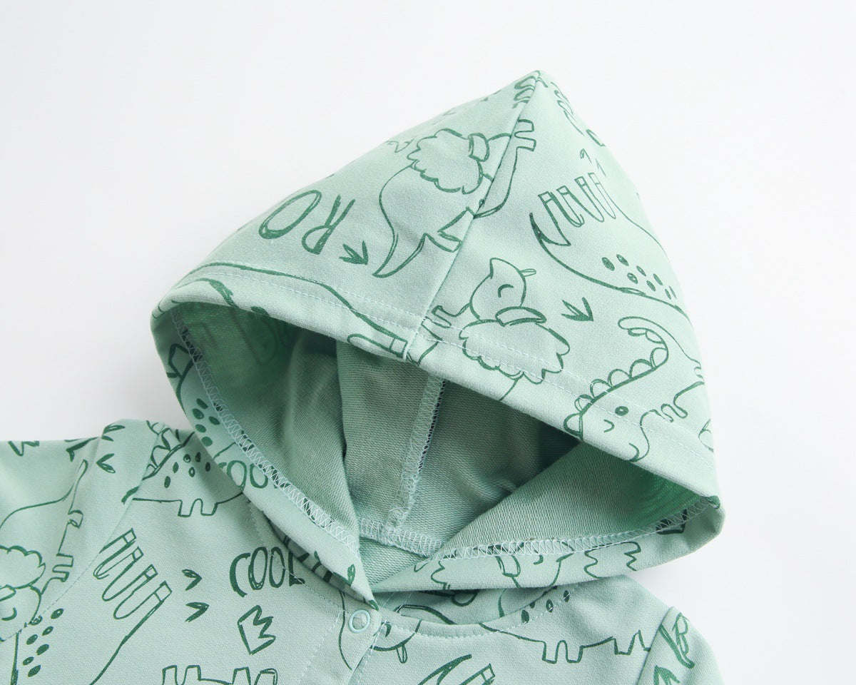 Baby wearing a cartoon dinosaur graphic romper with a matching hat, showcasing vibrant colors and snap button design.