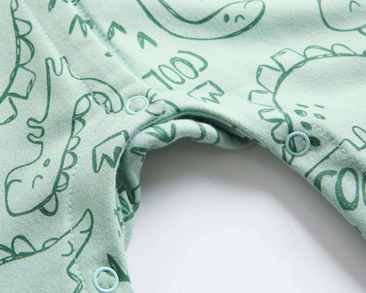 Baby wearing a cartoon dinosaur graphic romper with a matching hat, showcasing vibrant colors and snap button design.