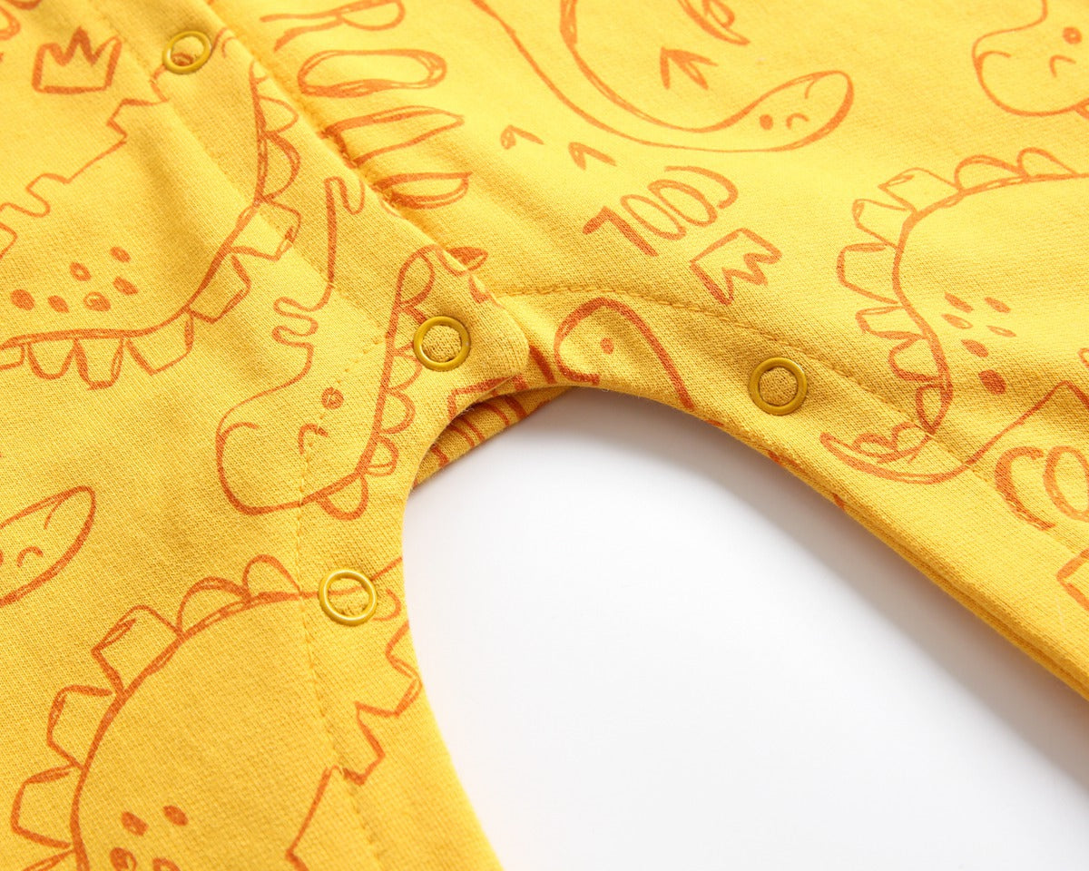 Baby wearing a cartoon dinosaur graphic romper with a matching hat, showcasing vibrant colors and snap button design.