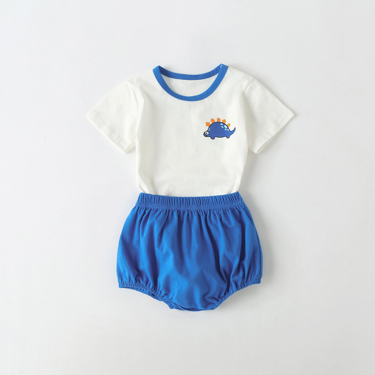 A playful baby outfit featuring a cartoon dinosaur pattern tee with contrast neck and solid shorts, perfect for summer wear.