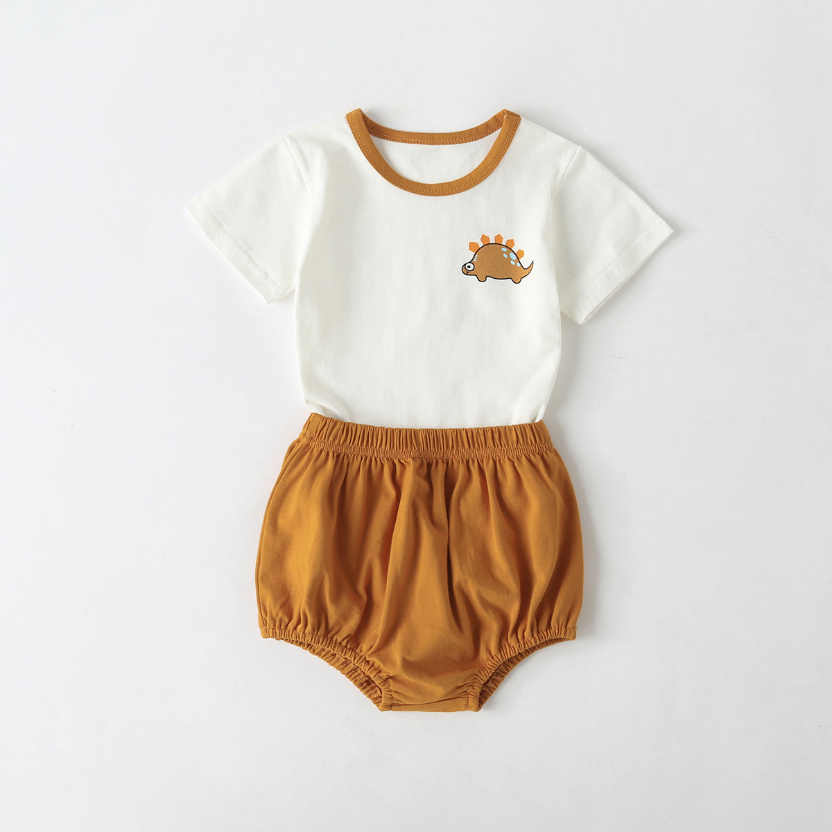 A playful baby outfit featuring a cartoon dinosaur pattern tee with contrast neck and solid shorts, perfect for summer wear.