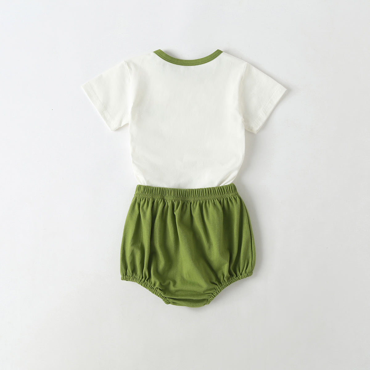 A playful baby outfit featuring a cartoon dinosaur pattern tee with contrast neck and solid shorts, perfect for summer wear.