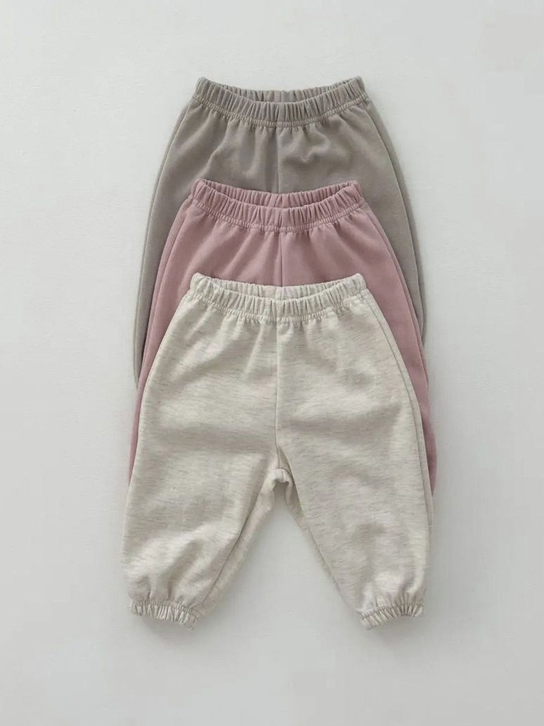 A set of baby cartoon hoodies with pants in pink and apricot colors, featuring playful designs suitable for both boys and girls.