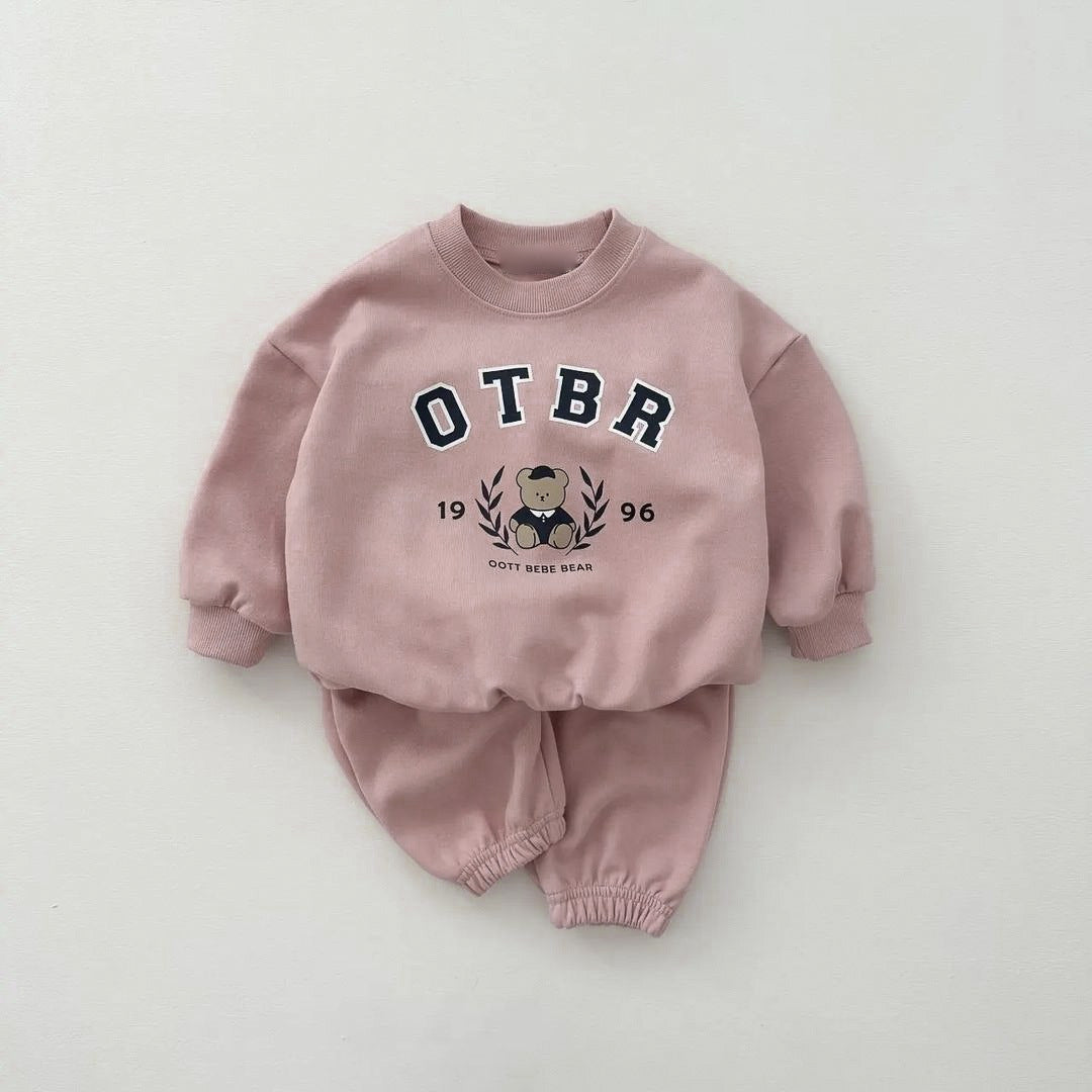 A set of baby cartoon hoodies with pants in pink and apricot colors, featuring playful designs suitable for both boys and girls.