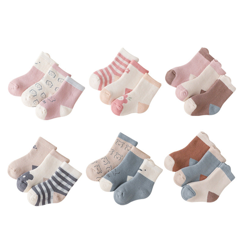 A pair of colorful baby socks featuring cartoon prints, made from soft cotton material, suitable for infants and toddlers.