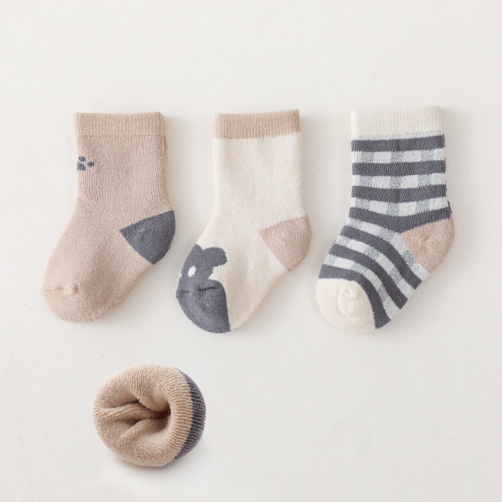 A pair of colorful baby socks featuring cartoon prints, made from soft cotton material, suitable for infants and toddlers.