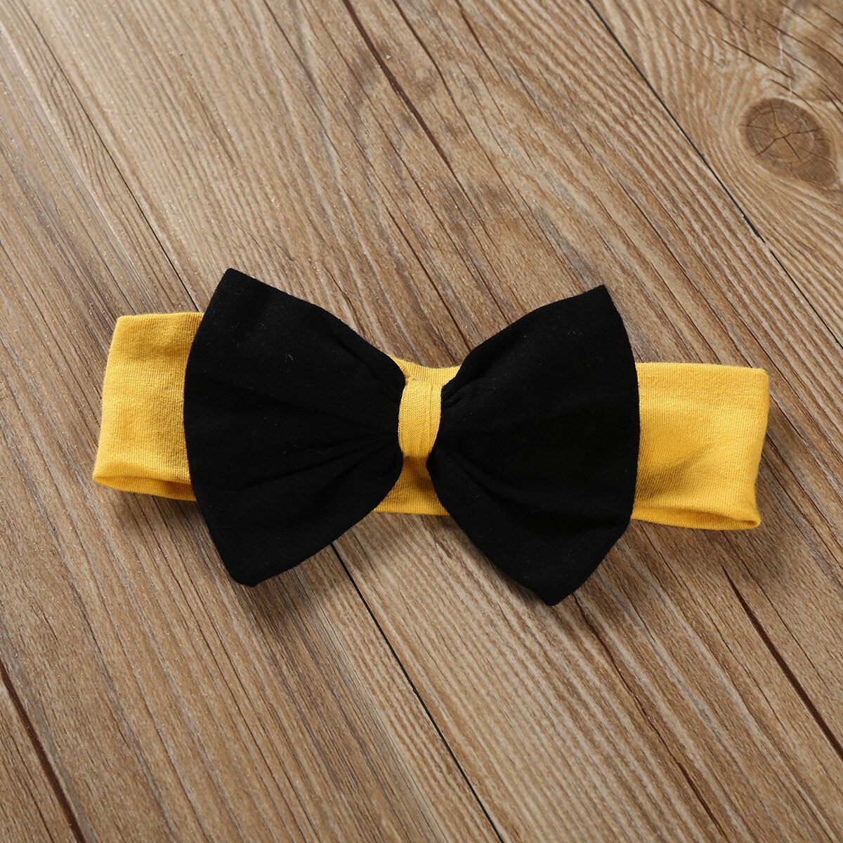 Yellow headband with black bow.