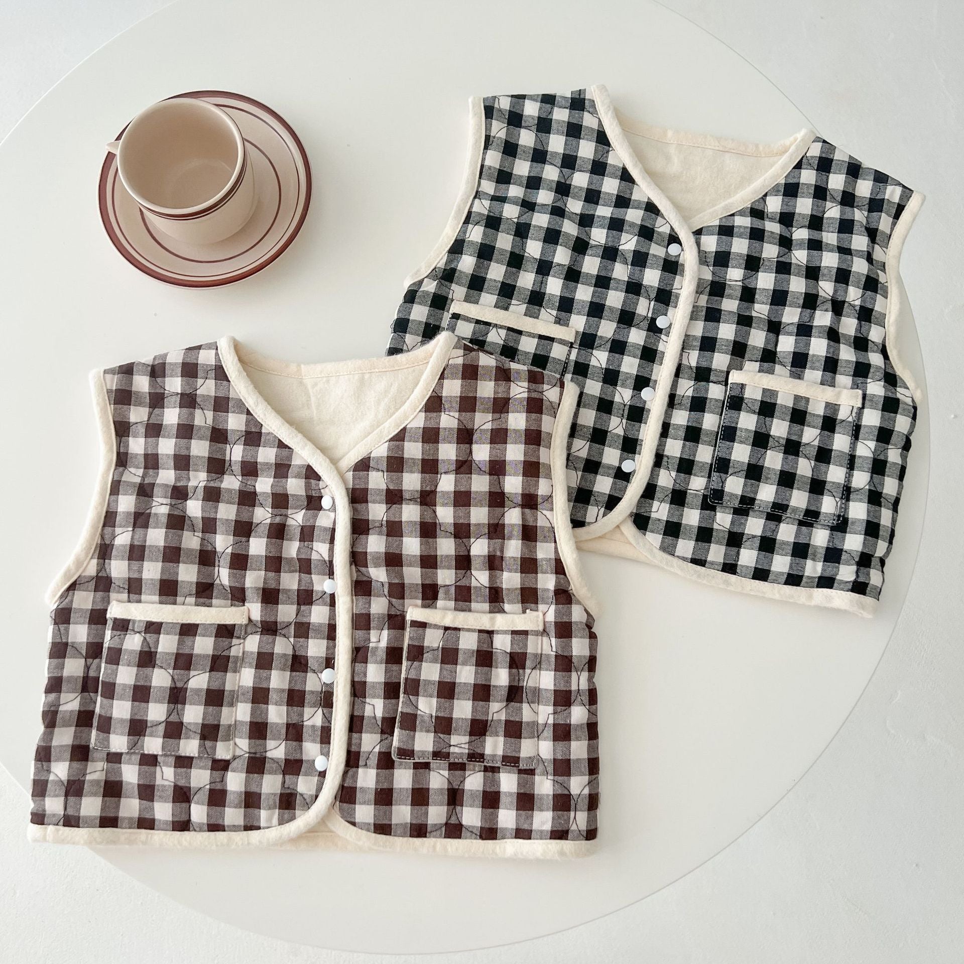 Baby Colorblock Plaid Pattern Sleeveless Thickened Quilted Vest Coat in black and brown, showcasing its stylish design and cozy material.