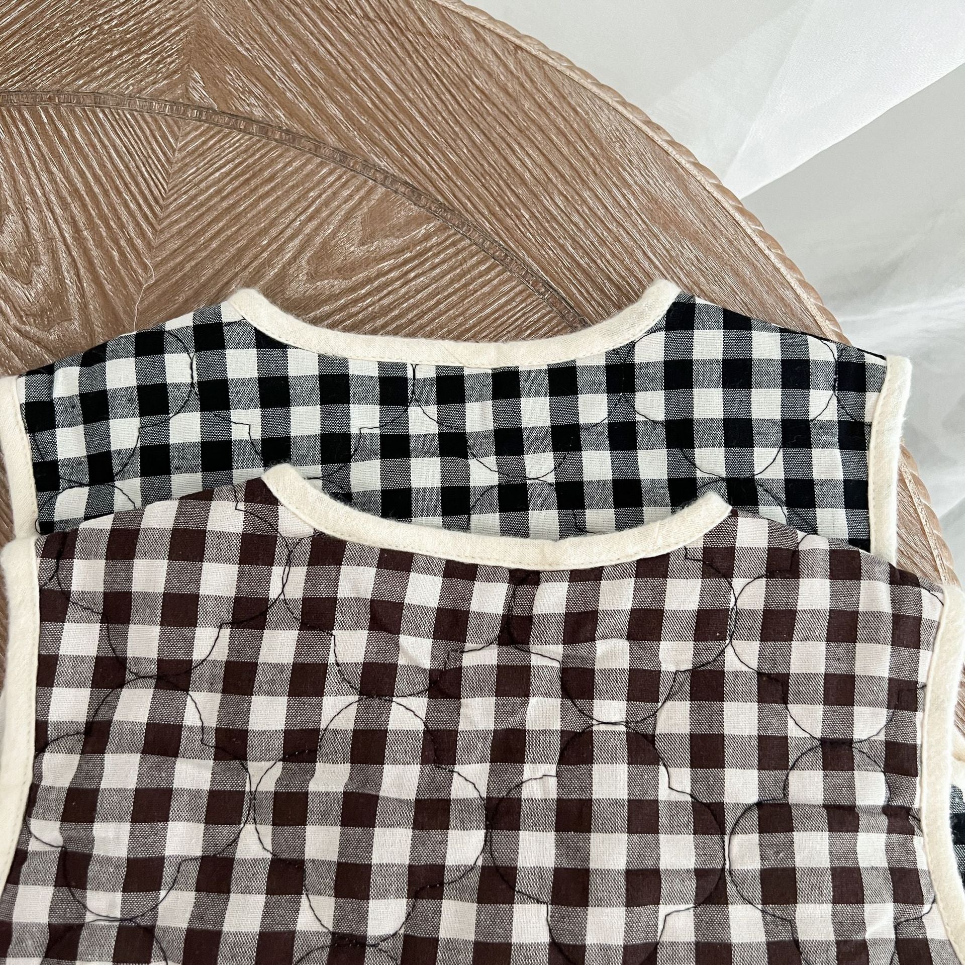 Baby Colorblock Plaid Pattern Sleeveless Thickened Quilted Vest Coat in black and brown, showcasing its stylish design and cozy material.