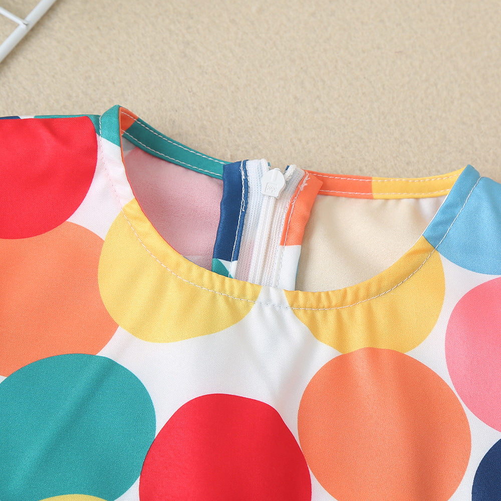 A cute baby dress featuring colorful polka dots and butterfly sleeves, perfect for summer wear.