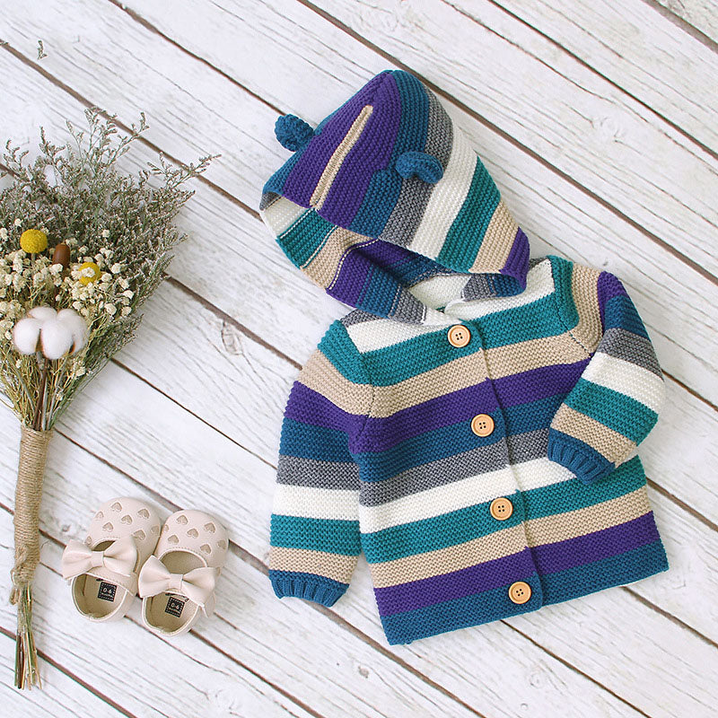 A colorful striped knitted cardigan with button front and matching hat for babies, featuring purple and green colors, perfect for boys and girls.