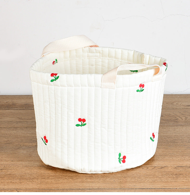 Stylish baby bottle storage basket with embroidered pattern, featuring a convenient handle and available in various colors.