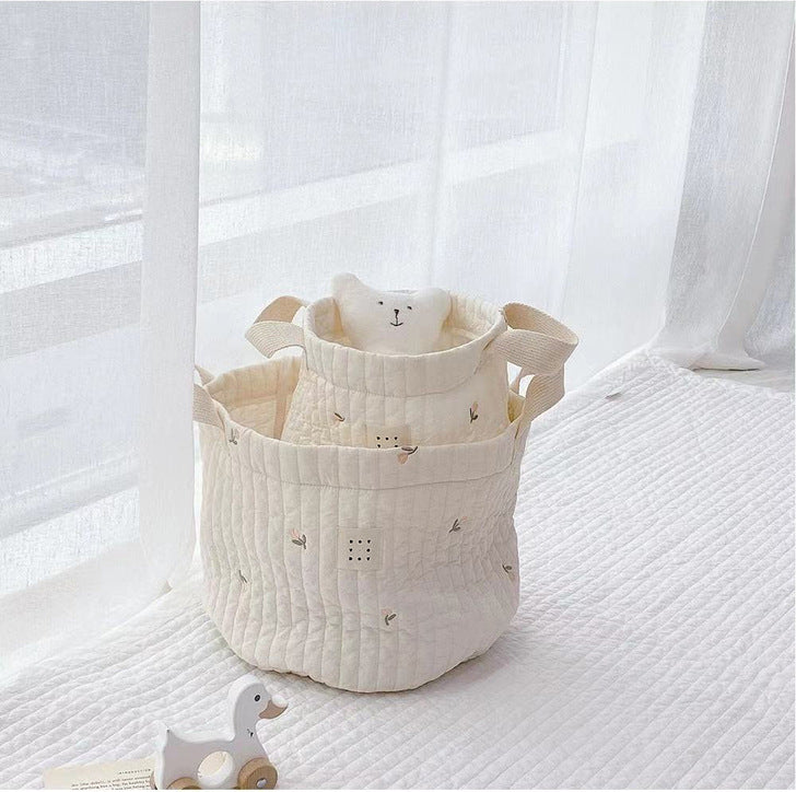 Stylish baby bottle storage basket with embroidered pattern, featuring a convenient handle and available in various colors.