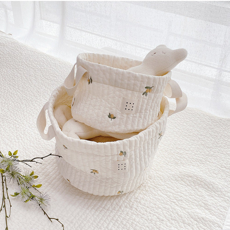 Stylish baby bottle storage basket with embroidered pattern, featuring a convenient handle and available in various colors.