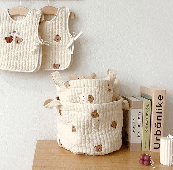 Stylish baby bottle storage basket with embroidered pattern, featuring a convenient handle and available in various colors.