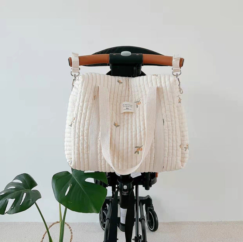 A vibrant Baby Embroidered Pattern Solid Color Storage Mommy Hanging Bag featuring multiple compartments, perfect for organizing baby essentials.