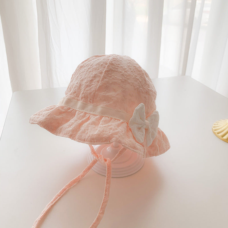 Baby sunshade hat in solid color with embroidered patterns and a bow decoration, perfect for stylish baby girls.