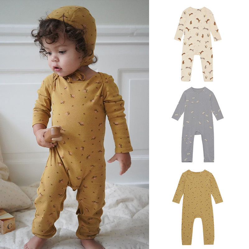 A soft baby jumpsuit featuring a floral and animal print pattern, designed for comfort and style, available in yellow, grey, and apricot.