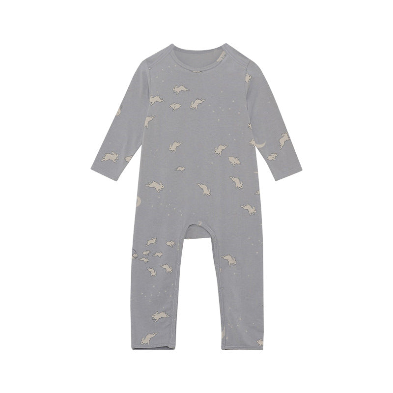 A soft baby jumpsuit featuring a floral and animal print pattern, designed for comfort and style, available in yellow, grey, and apricot.