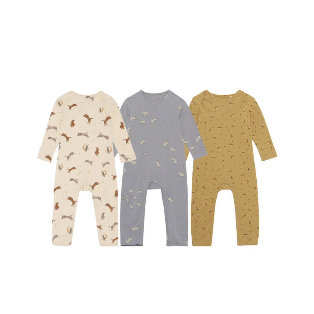 A soft baby jumpsuit featuring a floral and animal print pattern, designed for comfort and style, available in yellow, grey, and apricot.