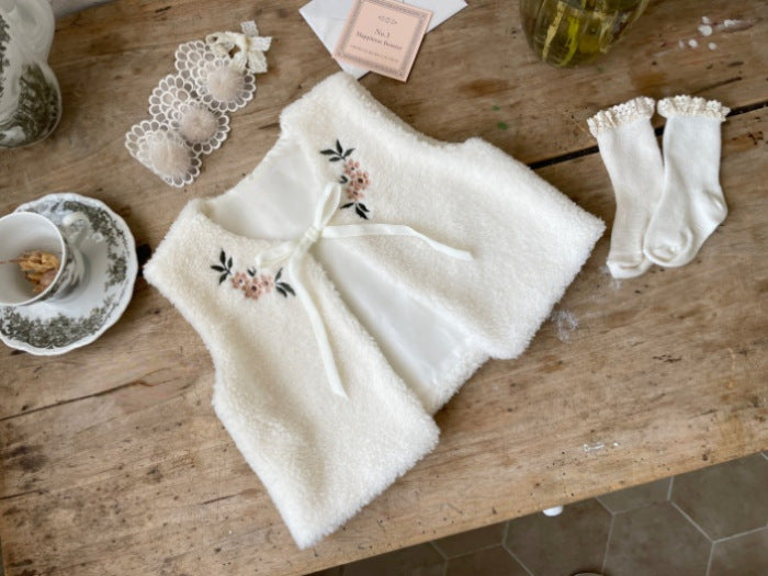 A cozy beige baby vest jacket made of lamb wool, featuring beautiful floral embroidery, perfect for baby girls.