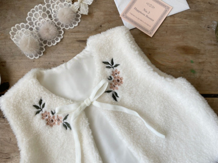 A cozy beige baby vest jacket made of lamb wool, featuring beautiful floral embroidery, perfect for baby girls.