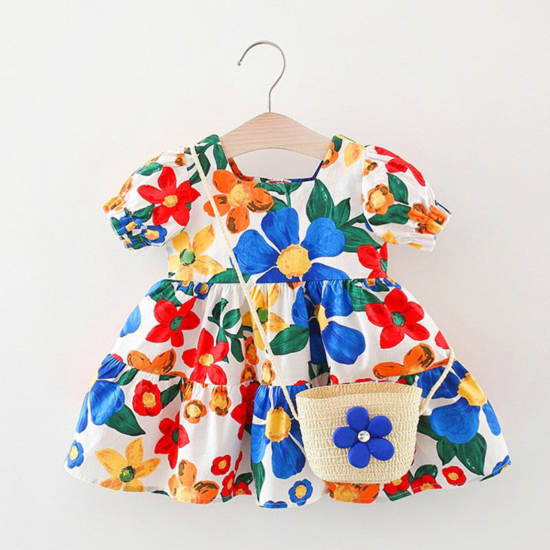 A cute baby girl wearing a floral pattern short sleeve crewneck dress in blue, perfect for summer outings.