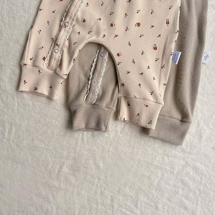 Baby jumpsuit featuring a floral pattern and solid color lace design, button front for easy dressing, available in khaki and apricot.