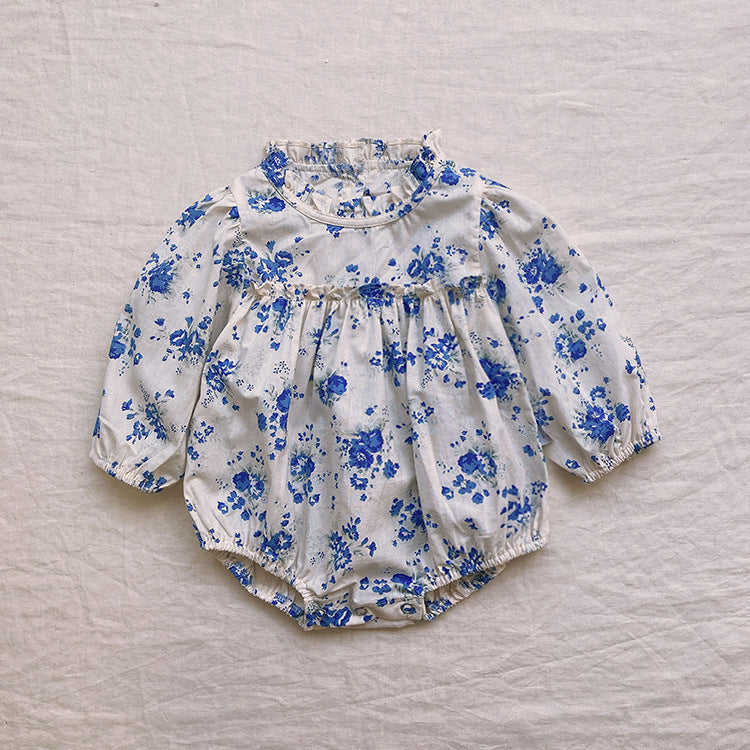 Baby girl wearing a floral pattern long sleeve onesie with a stand collar in pink color, looking adorable and comfortable.