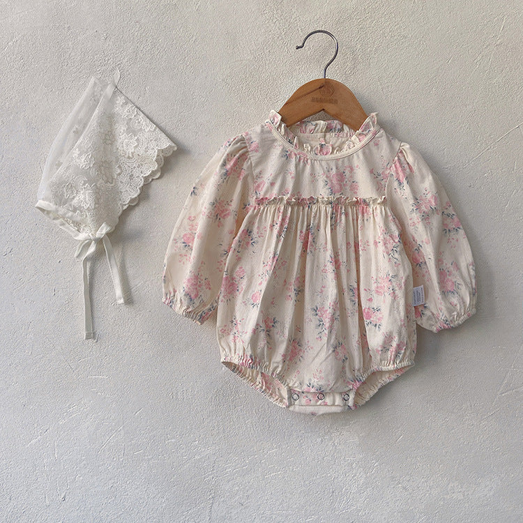 Baby girl wearing a floral pattern long sleeve onesie with a stand collar in pink color, looking adorable and comfortable.