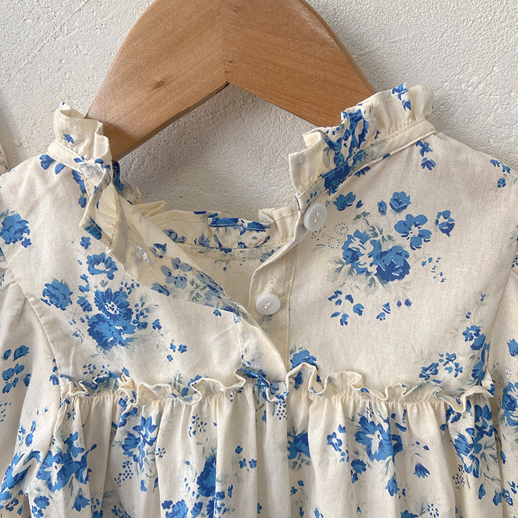 Baby girl wearing a floral pattern long sleeve onesie with a stand collar in pink color, looking adorable and comfortable.