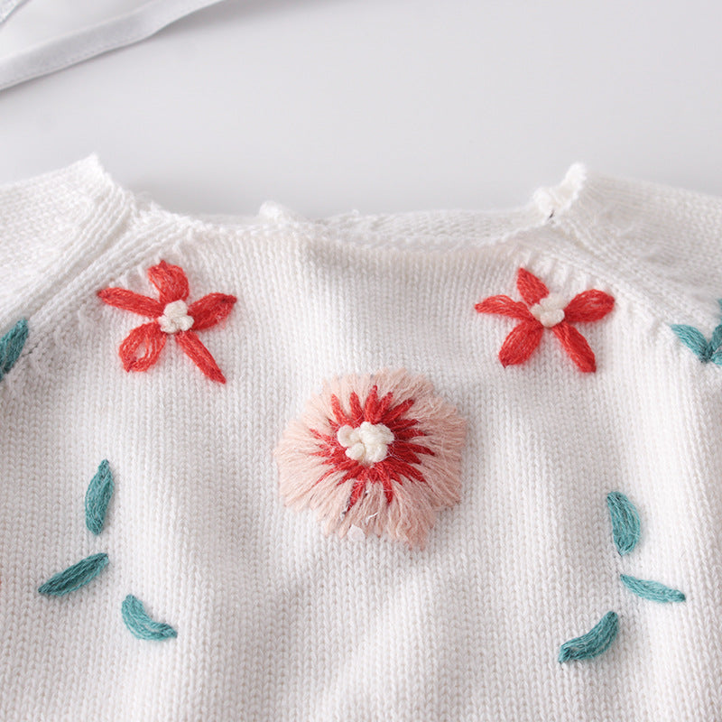 Baby girl floral embroidered knitted onesie in pink with contrast design, featuring a secure belted waist for comfort.