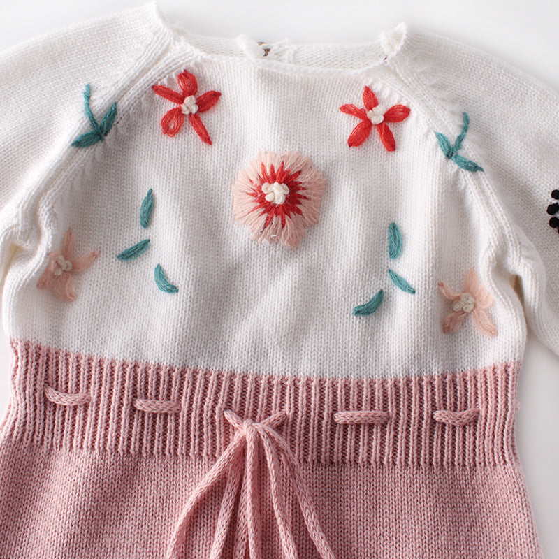 Baby girl floral embroidered knitted onesie in pink with contrast design, featuring a secure belted waist for comfort.