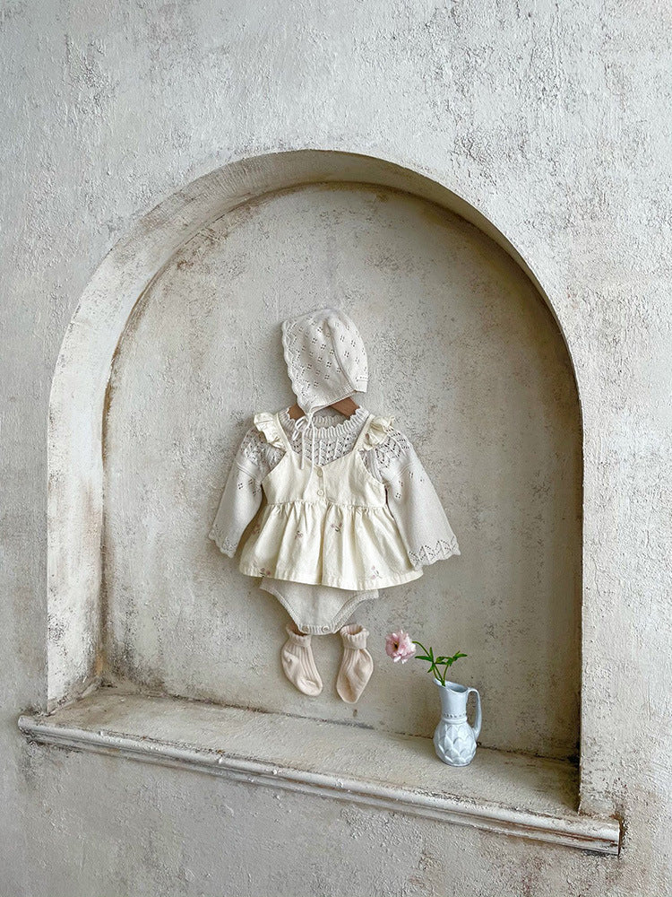 Baby girl wearing a floral embroidered ruffle sling top and shorts set in apricot color, showcasing delicate embroidery and ruffles.