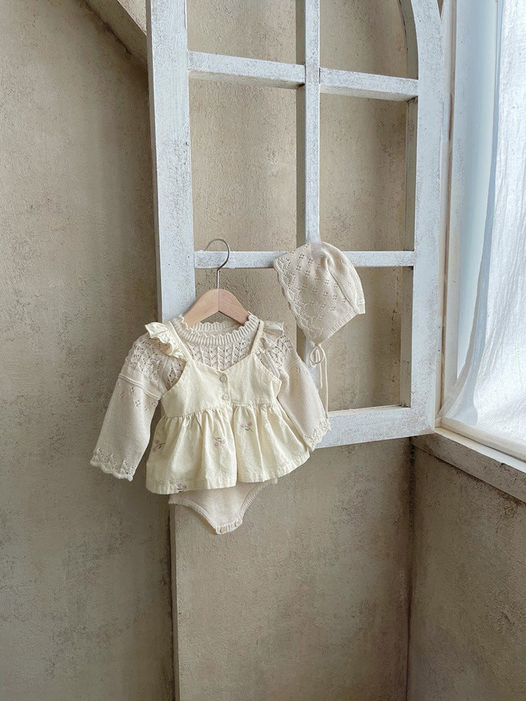 Baby girl wearing a floral embroidered ruffle sling top and shorts set in apricot color, showcasing delicate embroidery and ruffles.