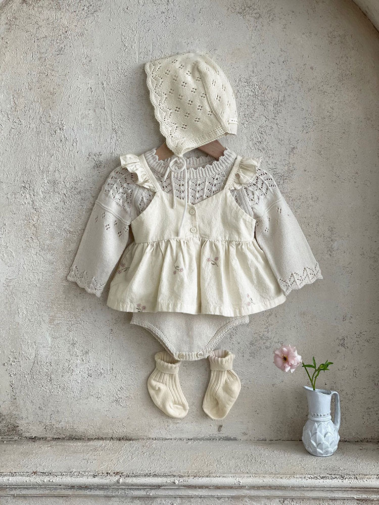 Baby girl wearing a floral embroidered ruffle sling top and shorts set in apricot color, showcasing delicate embroidery and ruffles.