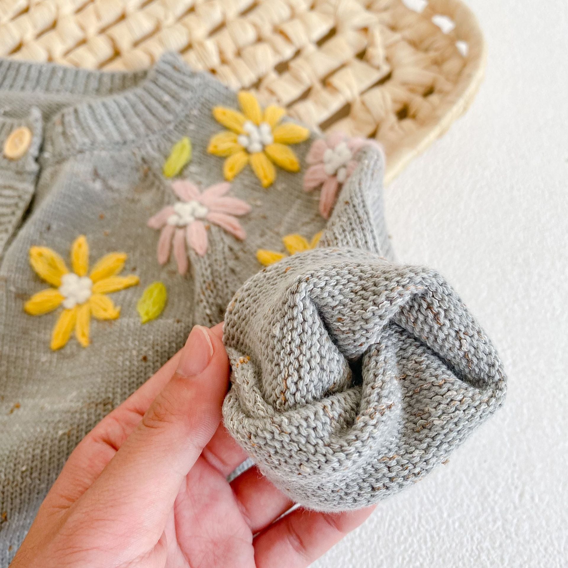 Baby girl wearing a grey floral embroidered knitted coat with single breasted closure, showcasing a stylish design for special occasions.