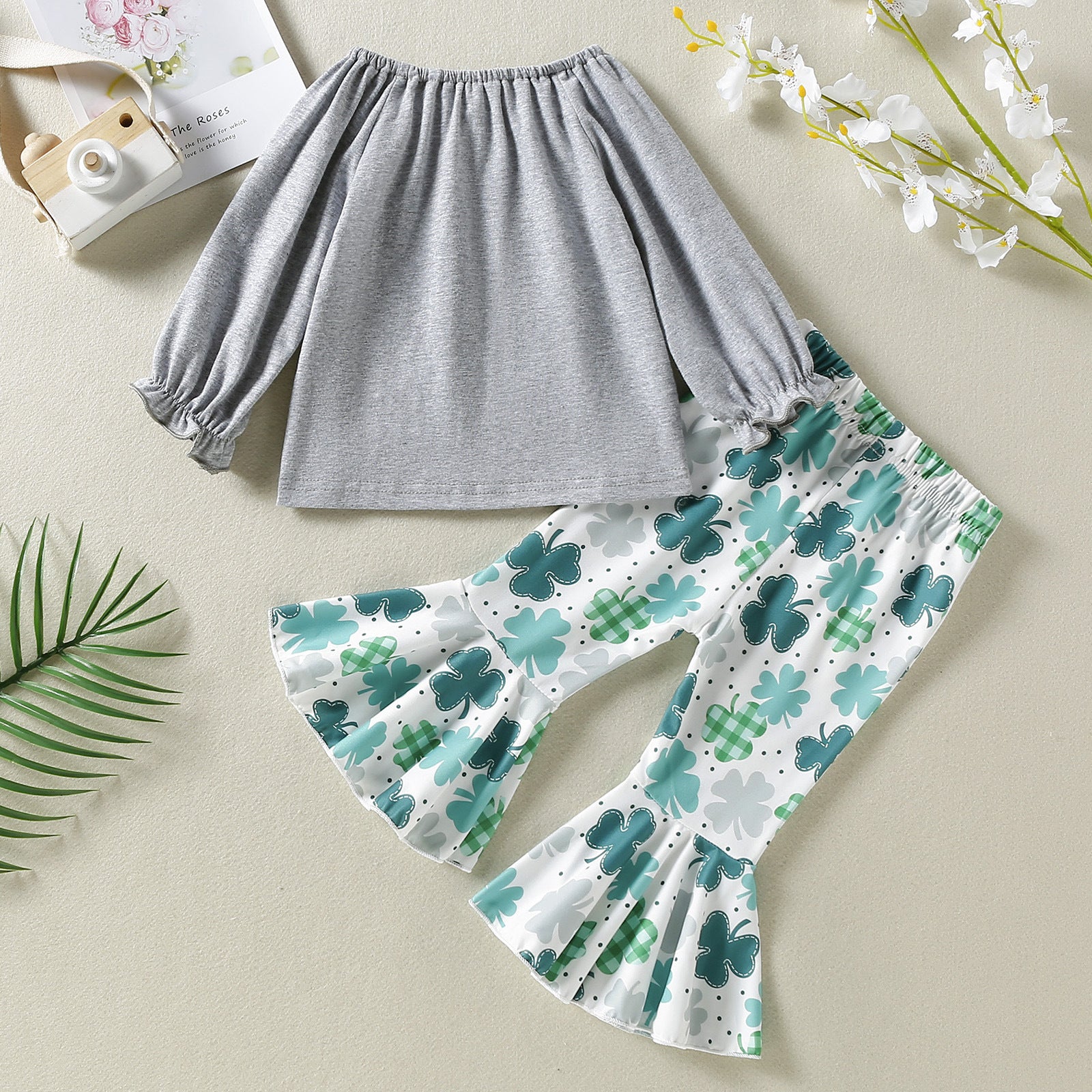 Baby girl outfit featuring a long sleeve top with 4-Leaves Grass Graphic and ruffle hem pants in green, perfect for summer play.