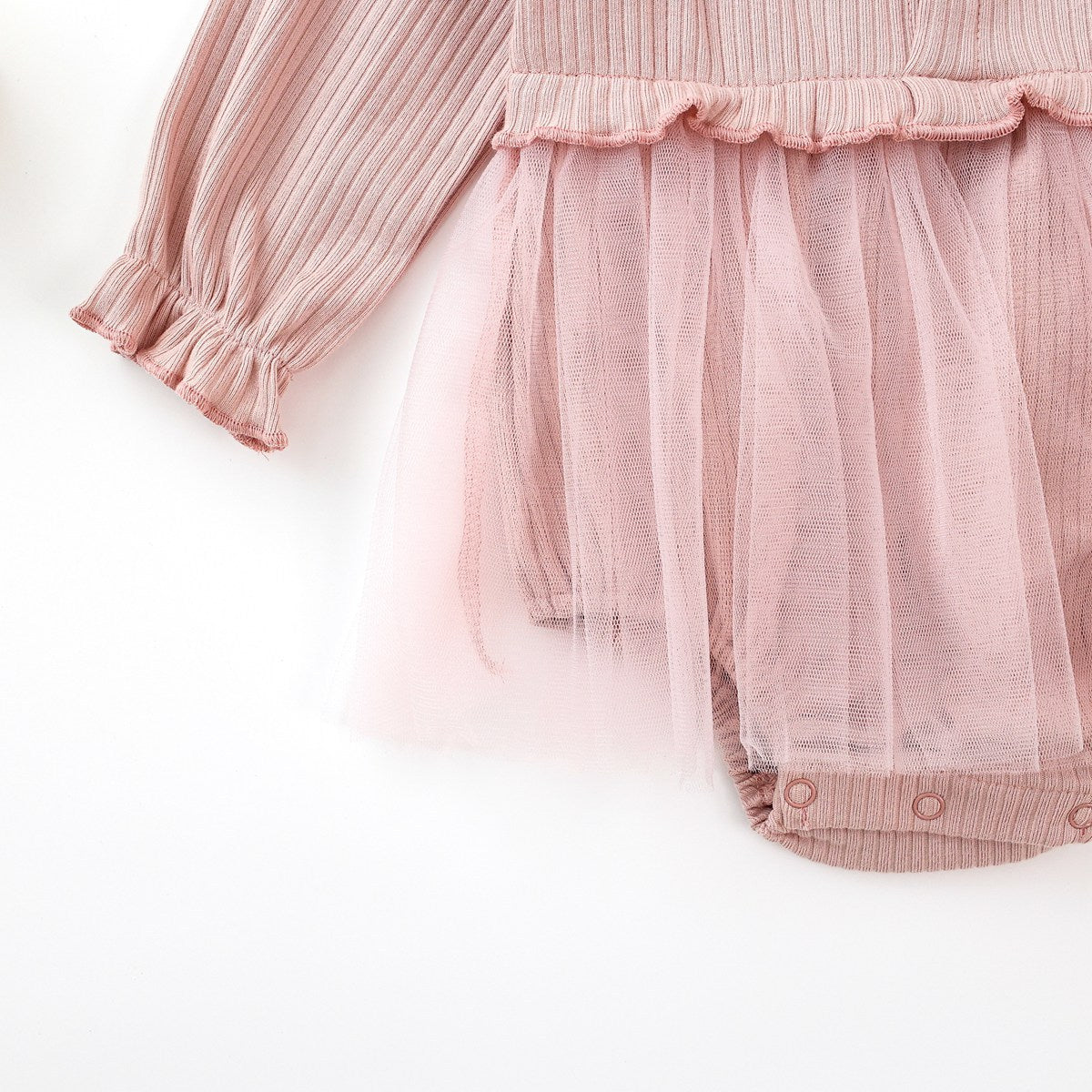 Baby girl onesie dress featuring floral patches and mesh overlay in white and pink colors.