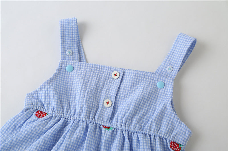 Adorable baby girl wearing a plaid jumpsuit with strawberry embroidery and snap button closure, showcasing a playful summer outfit.