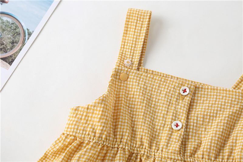 Adorable baby girl wearing a plaid jumpsuit with strawberry embroidery and snap button closure, showcasing a playful summer outfit.