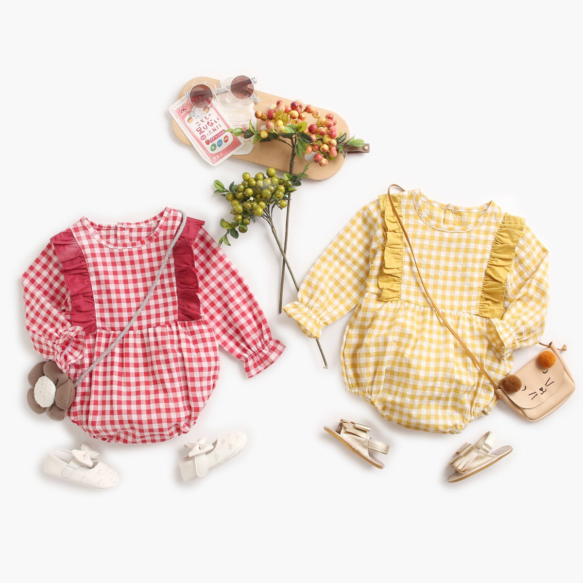 Baby girl bodysuit featuring a plaid pattern with ruffles and puff sleeves in red and yellow colors.