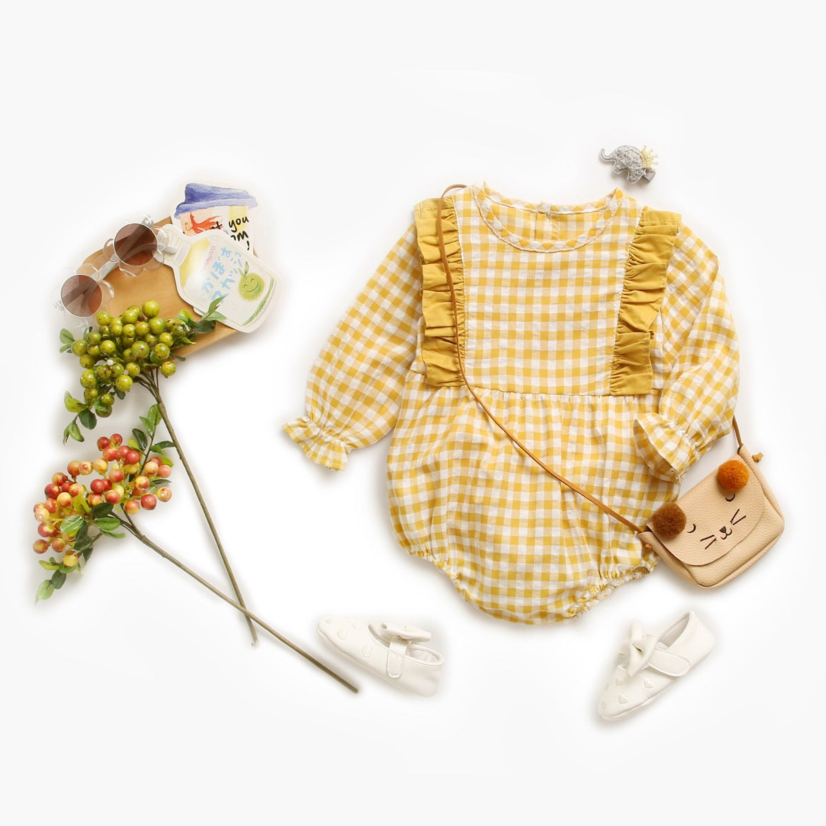 Baby girl bodysuit featuring a plaid pattern with ruffles and puff sleeves in red and yellow colors.